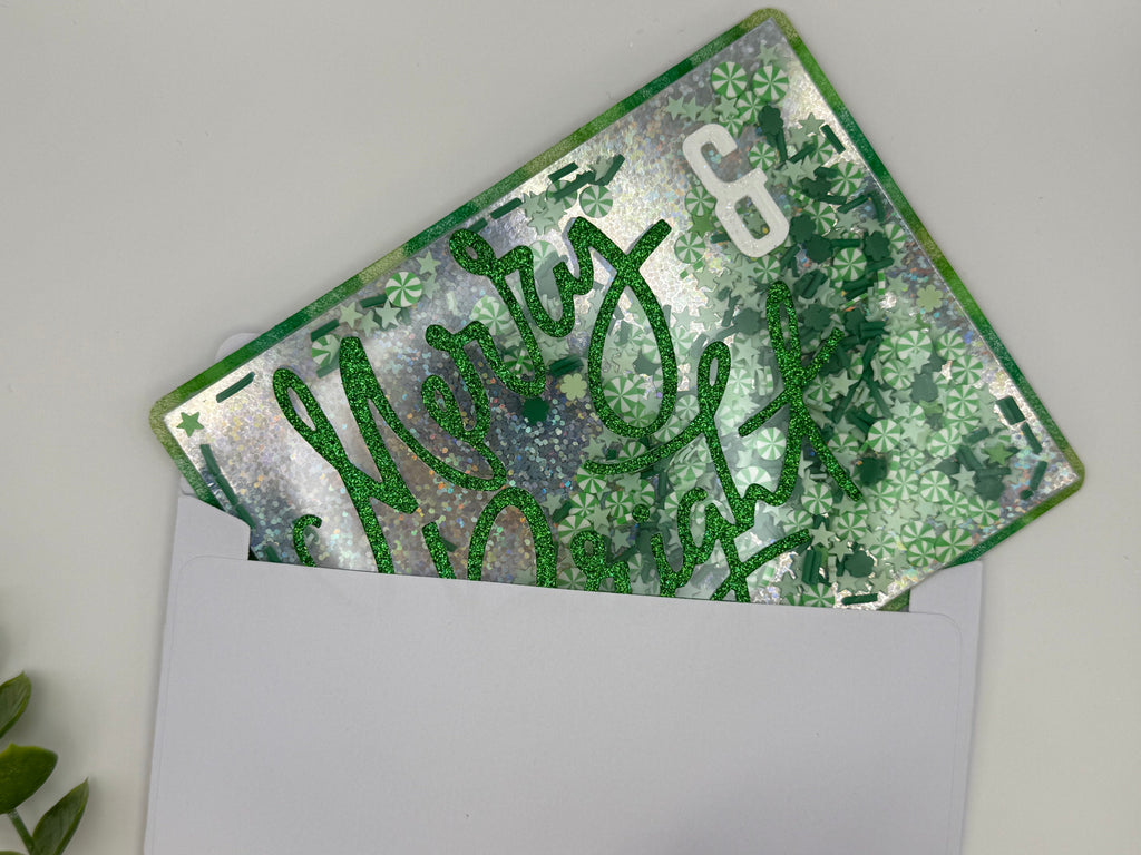 Green glittery card with 'Merry & Bright' text on a white background