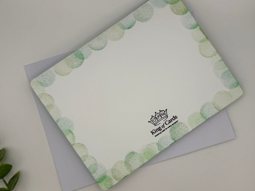 Greeting card with green border design and 'King of Cards' logo on a white background