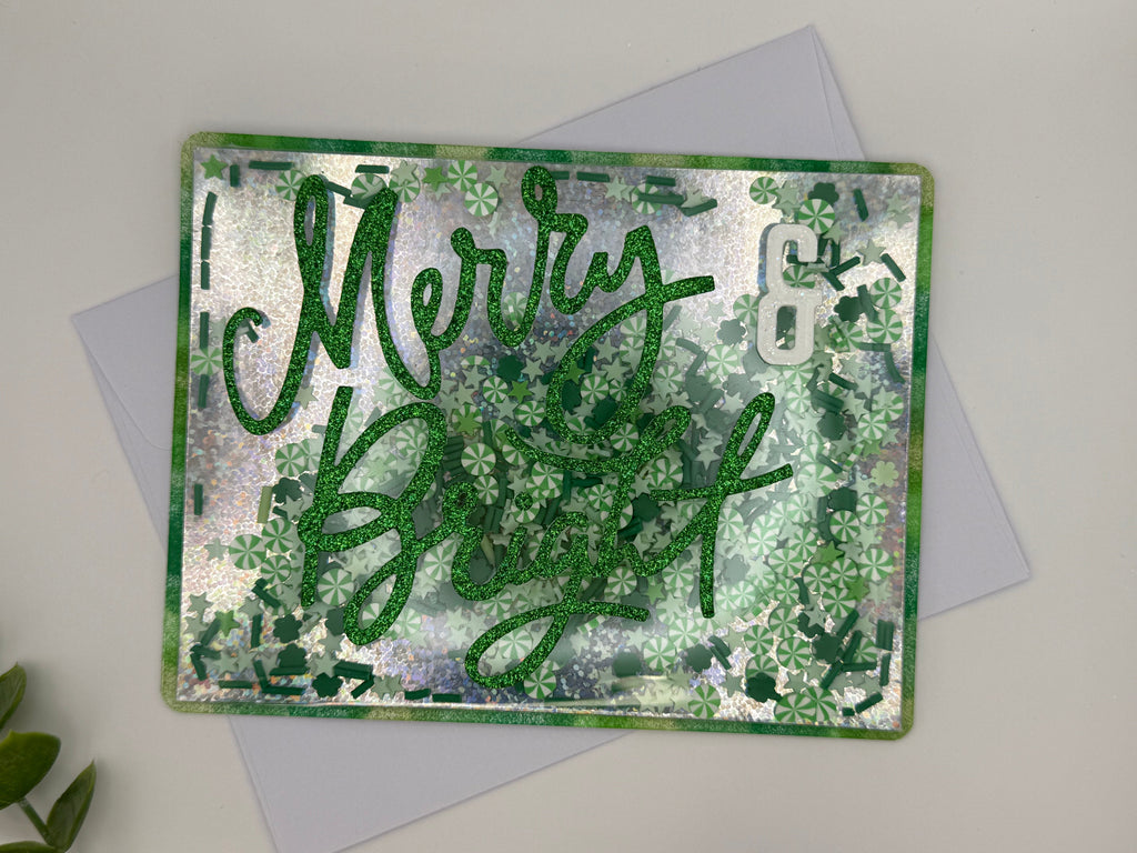 Greeting card with 'Merry Christmas' text on a textured green and silver background