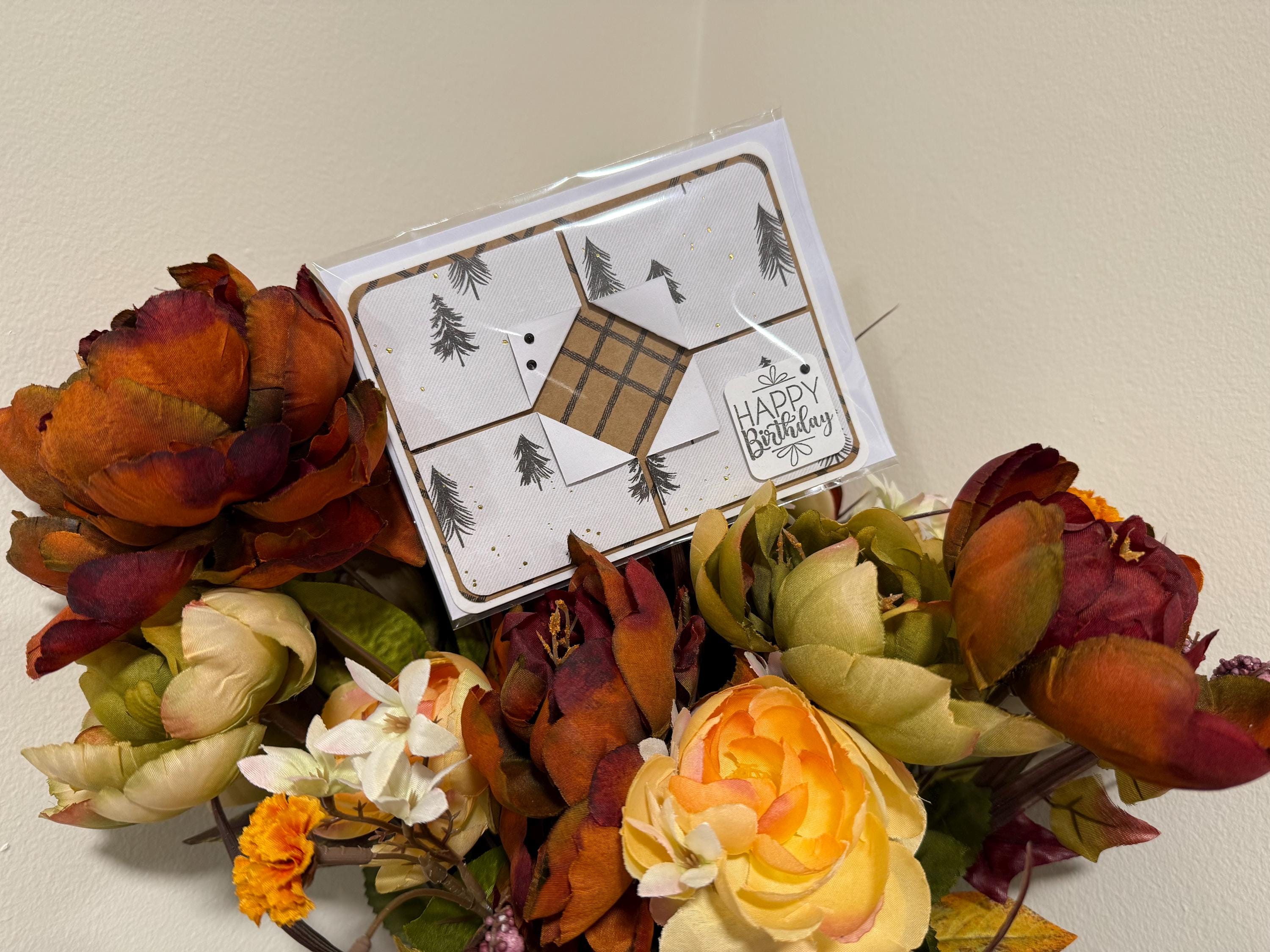 Greeting card with autumn-themed flowers on a light background